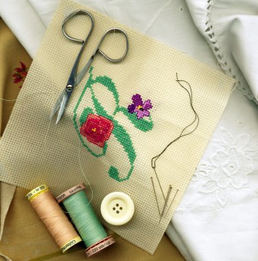 Sewing needle with bobbins of cotton thread and needlework clipart