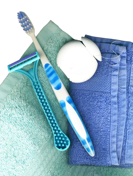 Toothbrush, with floss and towels — Stock Photo, Image