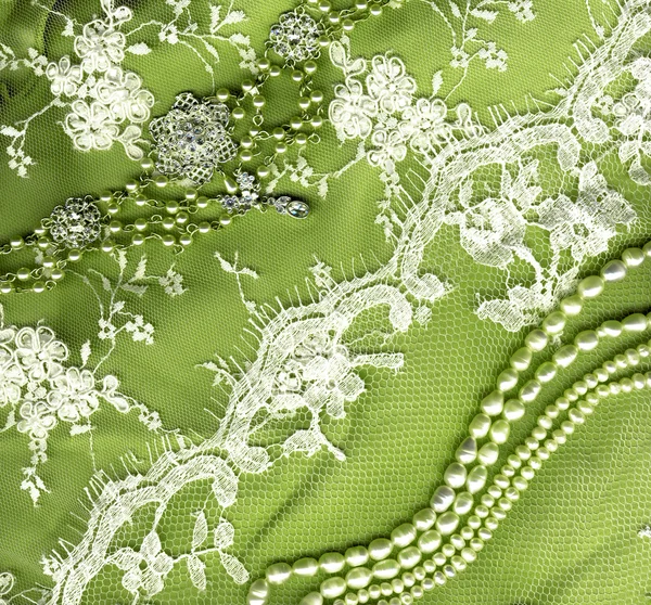 Vintage wedding dress lace on green background texture — Stock Photo, Image