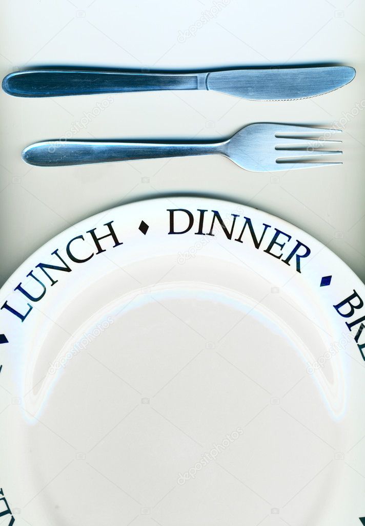 Knife and fork with white plate