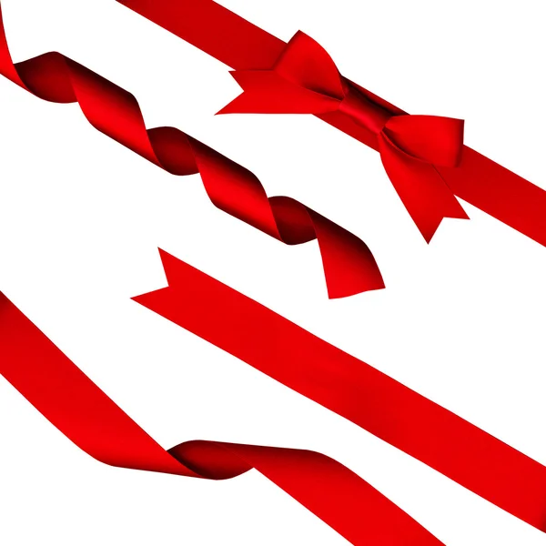 Strips of red shiny ribbon and a bow over a white background — Stock Photo, Image