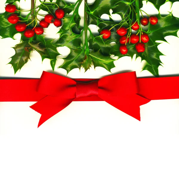 Christmas card with holly and red bow — Stock Photo, Image