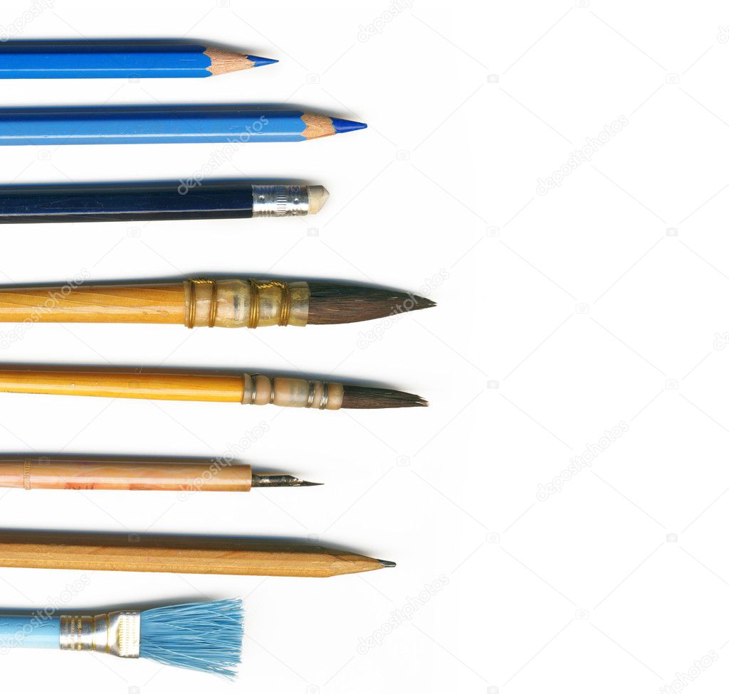 Different brushes, pencils and tools of an artist, isolated on white backgr