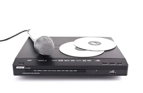 DVD-програвач, диски та мікрофон, ізольовані Ліцензійні Стокові Фото