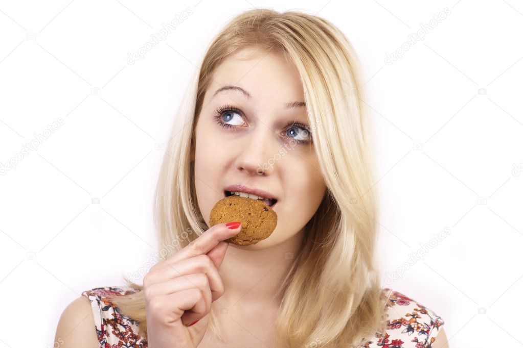 Young cute women eating cookie on white backgroung