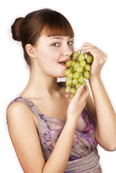 stock image Young woman eating grapes