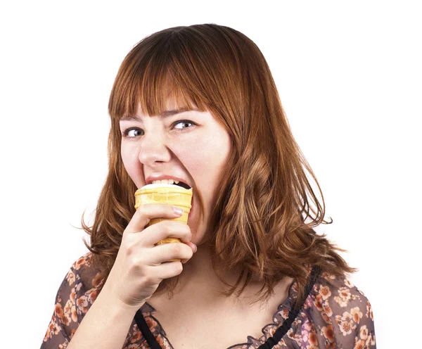 Portrait of funny expressive girl eating ice-cream isolated Stock Photo