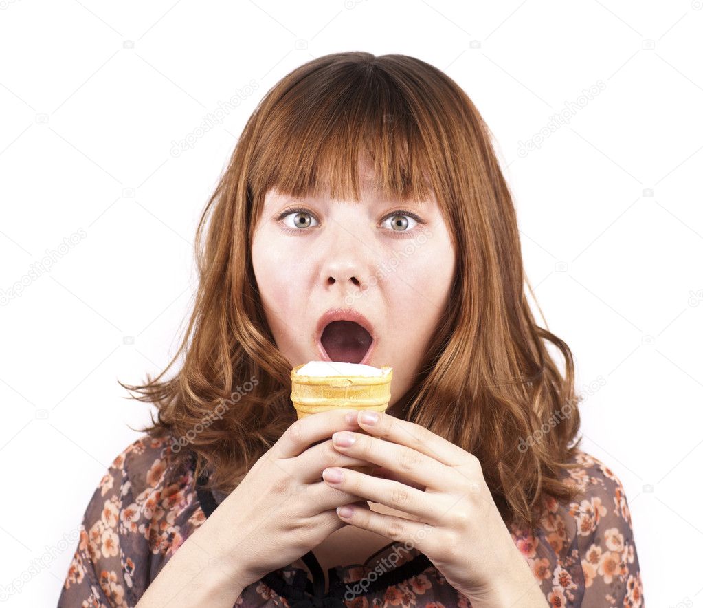 Portrait of funny expressive girl eating ice-cream isolated