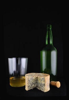 Cheese cabrales and bottle of cider. clipart