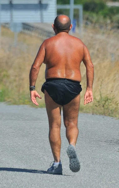 stock image Man walking with much heat.