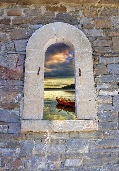 Traditional boat in lake through an old door in Crete island, Greece — Stock Photo, Image