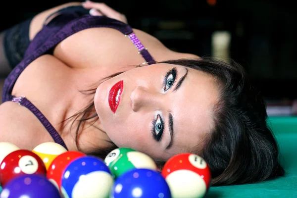Portrait of sexy girls lying on the table for a game of billiard — Stock Photo, Image