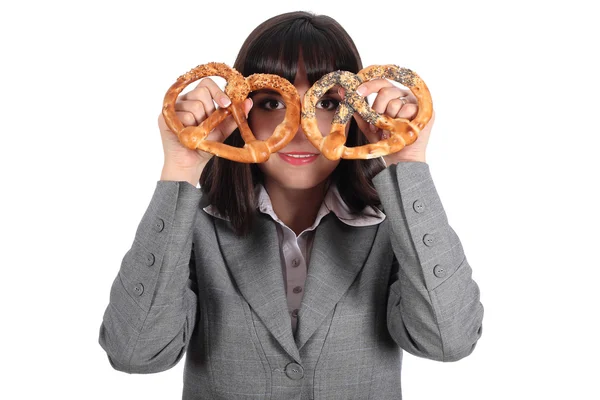 Young woman looking through pretzel — Stock Photo, Image