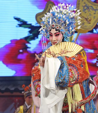 Pretty chinese Hui opera performer make a show on stage clipart