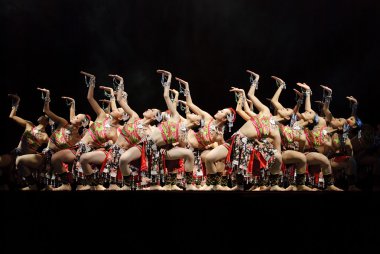 Chinese dancers perform modern group dance on stage clipart