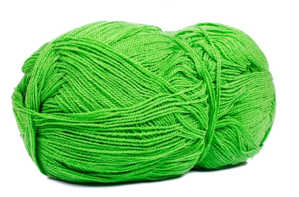 Dark green thread spool with purple crochet hook, isolated on