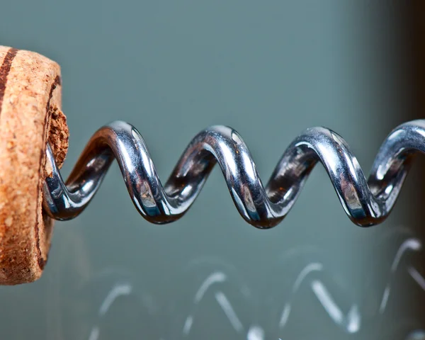 Corkscrew and cork on a glass table — Stock Photo, Image