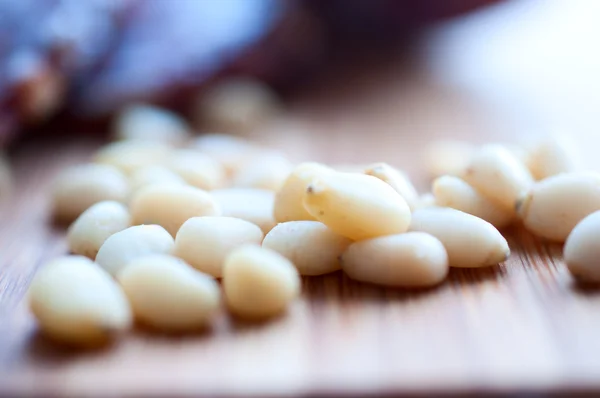 Shelled pine nuts on a wooden board — Stock Photo, Image