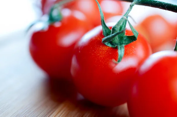 Red cherry tomatoes on a cutting — Stock Photo, Image