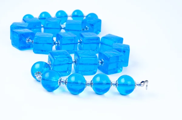 stock image Blue glass beads on white background