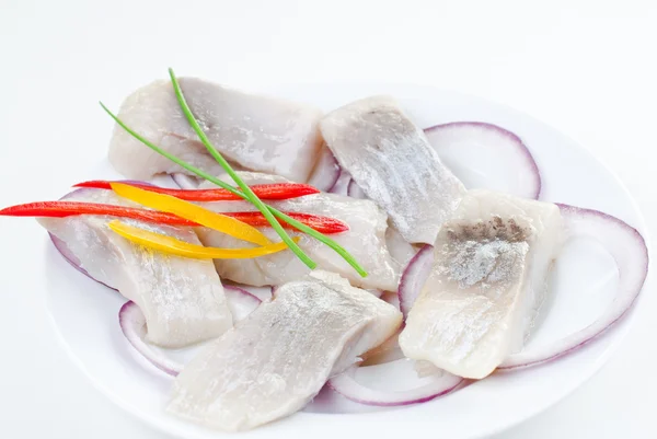 stock image Marinated herring bites on a plate