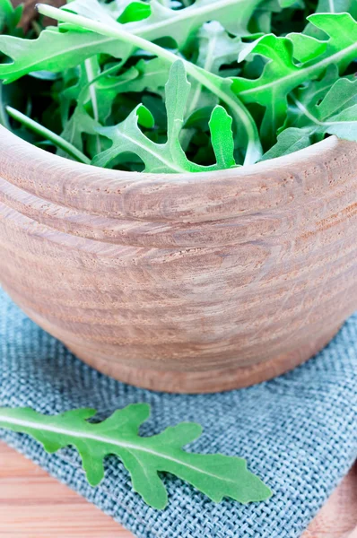 Fresh rucola in wooden bowl — Stock Photo, Image