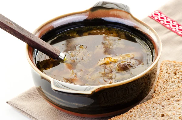 Brown bowl of mushroom soup with spoon — Stock Photo, Image