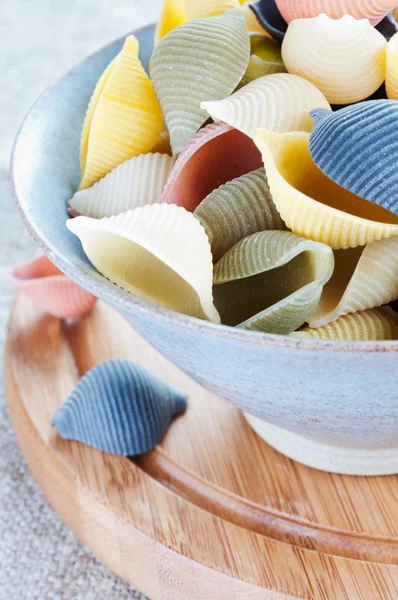 Pasta in bowl on a wooden board — Stock Photo, Image
