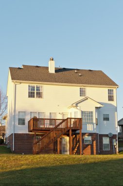 Back view of a typical american two story house with basement an clipart