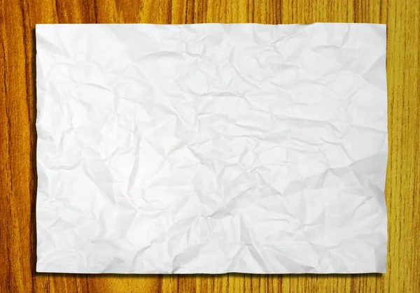 Papel crumpled branco no fundo de madeira — Fotografia de Stock