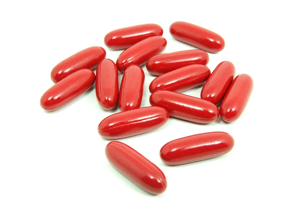 Pilules rouges isolées sur fond blanc — Photo