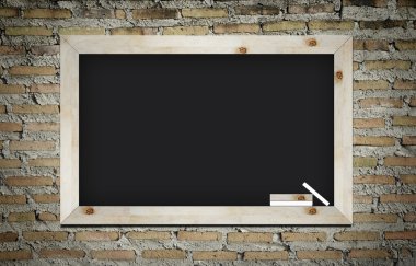 Empty blackboard with wooden frame and chalks on wall background clipart