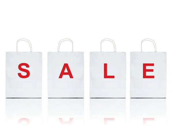 White shopping bags with the word sale on white — Stock Photo, Image