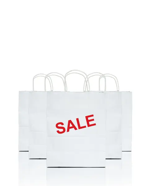 stock image White shopping bags with the word sale on white