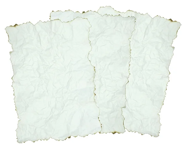 Zerknülltes Papier mit verbrannten Rändern über weißem Papier — Stockfoto