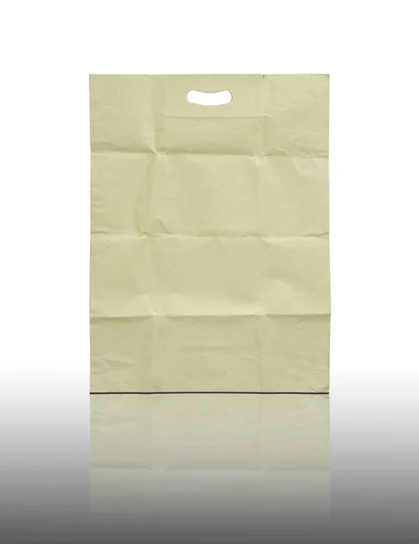 Brown paper bag on reflect floor and white background — Stock Photo, Image