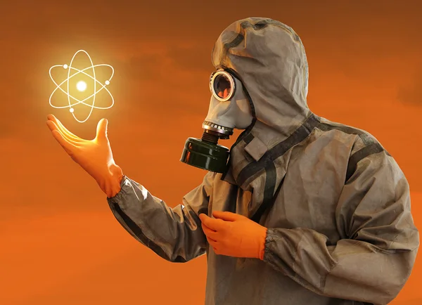 stock image Man In Protective Costume With The Shining Nuclear Power Symbol