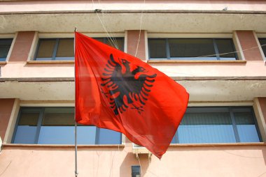 Albanian flag waving in Tirana clipart