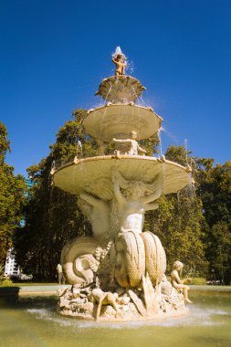 Water fountain with sculpture facade clipart