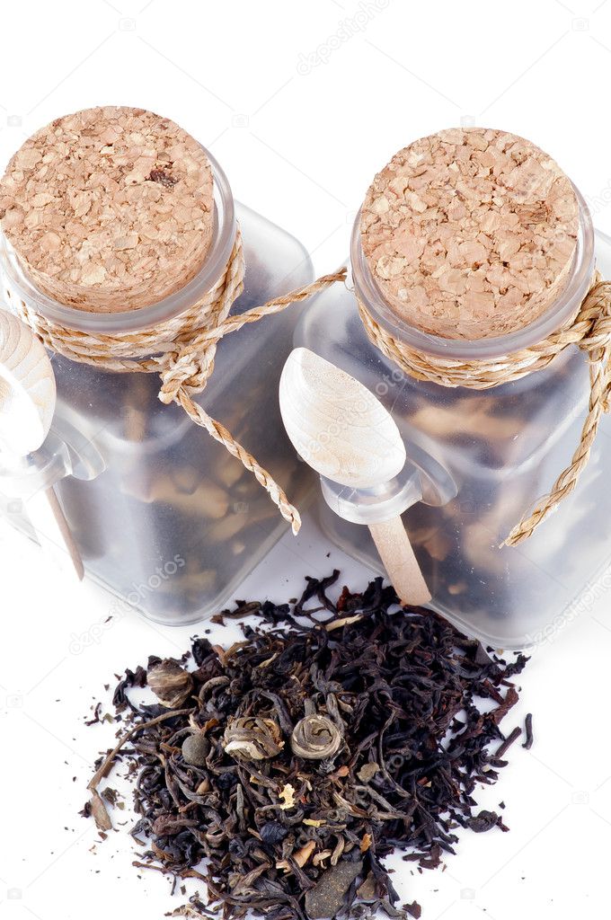 Tea leaves in transparent parisons with wooden spoon