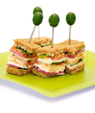 Snacks of Classical BLT Club Sandwich isolated on green plate clipart