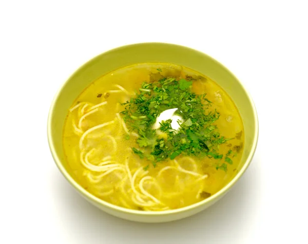 Bowl homemade chicken noodle soup with greens and sour cream — Stock Photo, Image