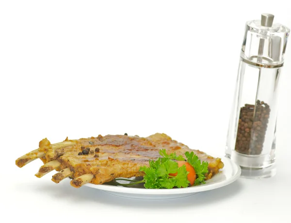 Barbecued pork ribs on white plate — Stock Photo, Image