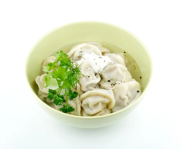 Stock image Meat pelmeni with sour cream and greens