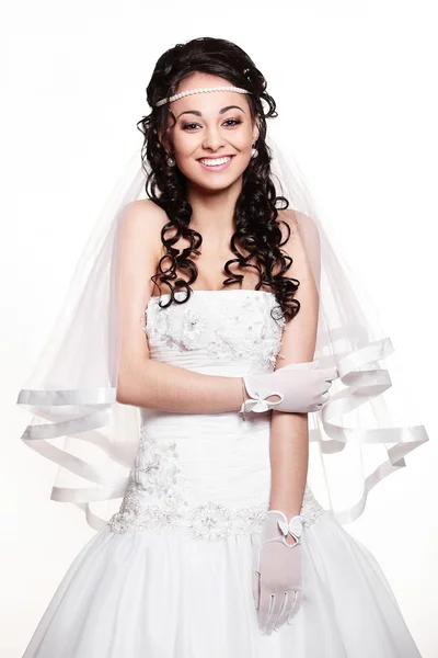 Happy sexy beautiful bride brunette girl in white wedding dress with hairstyle and bright makeup on white background — Stock Photo, Image