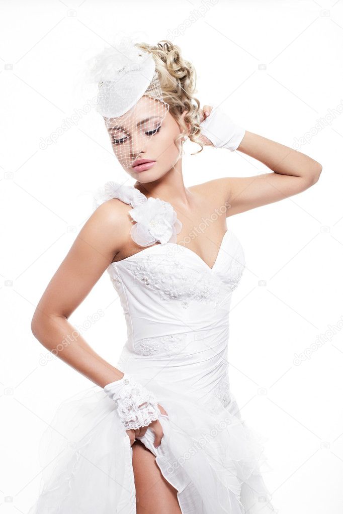 Happy smiling sexy beautiful bride blond girl in white wedding dress with hairstyle and bright makeup on white background