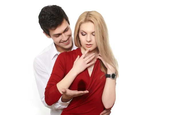 Young romantic handsome man presenting jewelry in red attractive case to gi — Stock Photo, Image