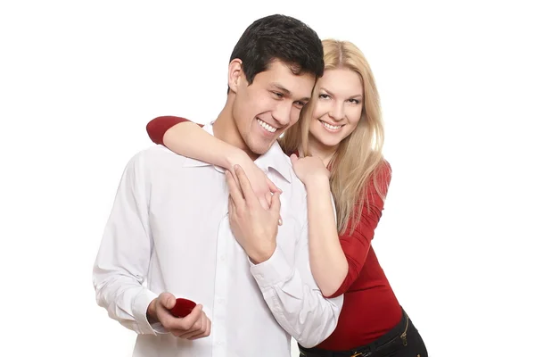 Young romantic handsome man presenting jewelry in red attractive case to gi — Stock Photo, Image