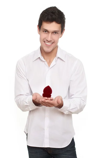 Attractive blond man holds a gift box that holds jewellery for Valentines D — Stock Photo, Image