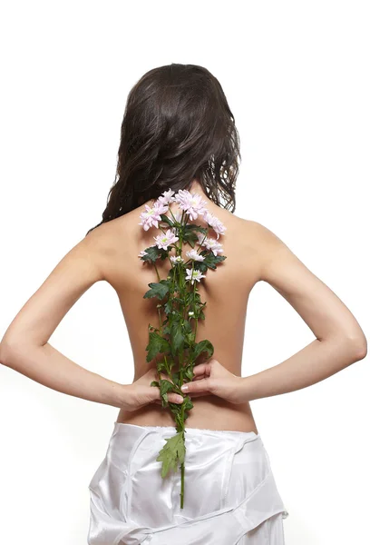 Красива дівчина спиною з квіткою ізольована на білому — стокове фото